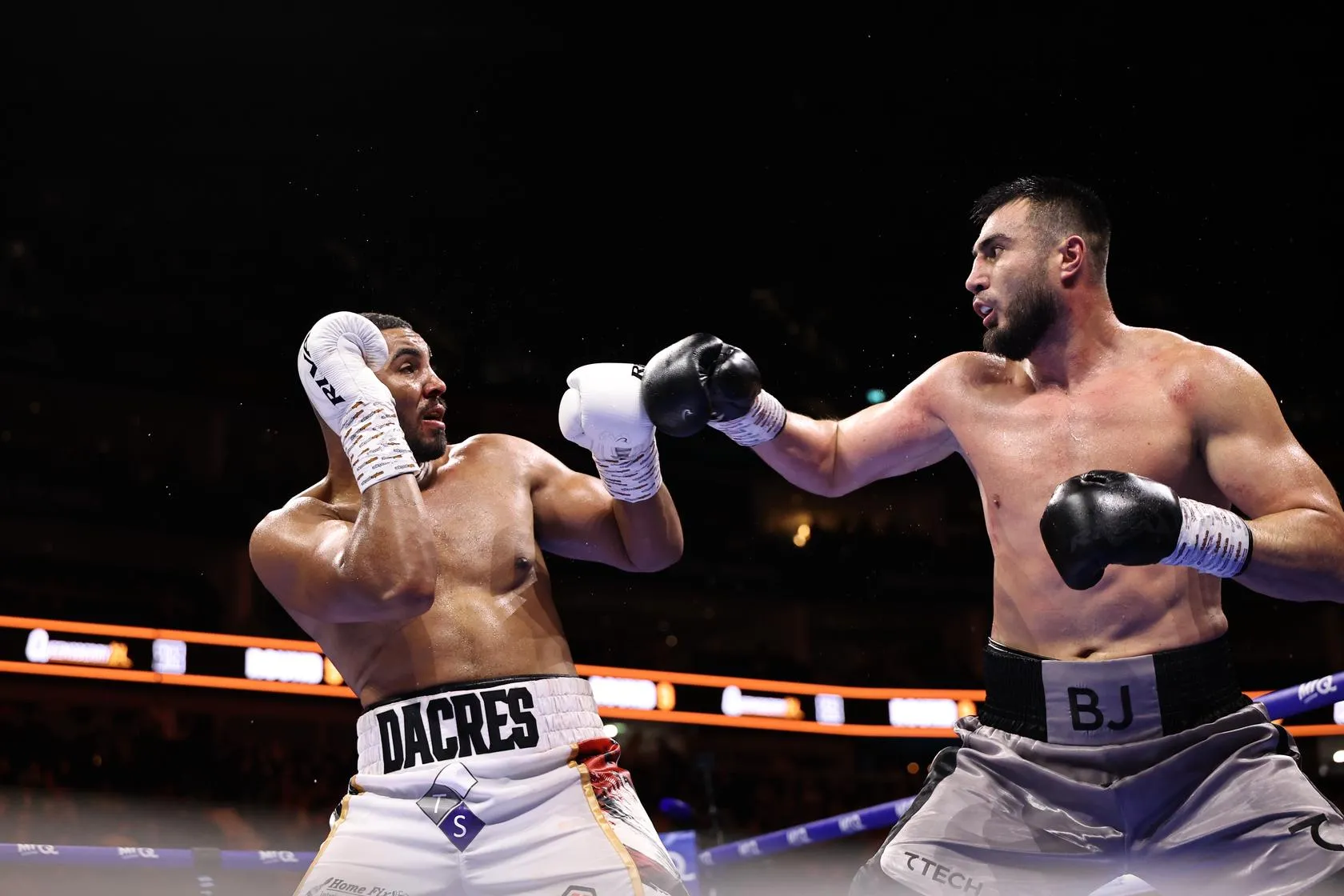 Bakhodir Jalolov [right] dominates Solomon Dacres on his way to a points win in London on October 17, 2026